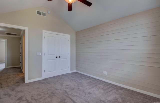 106 Venezia Ln, Maumelle, AR 72113 - unfurnished bedroom featuring carpet flooring, vaulted ceiling, a closet, wood walls, and a ceiling fan