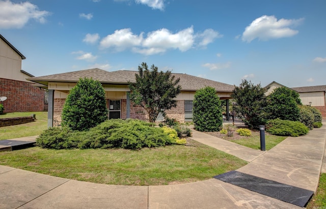 106 Venezia Ln, Maumelle, AR 72113 - view of property hidden behind natural elements with a front lawn and roof with shingles