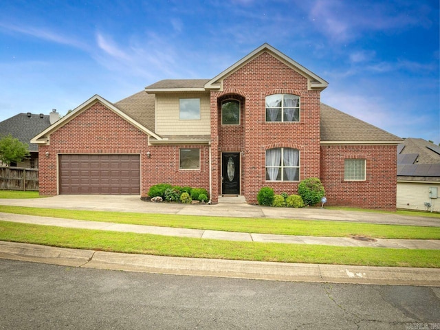 14 Woodridge Dr, Little Rock, AR 72204 - traditional-style home featuring brick siding, a garage, driveway, and a shingled roof