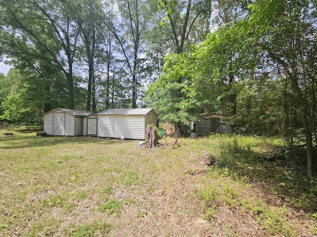 11806 Veronica, North Little Rock, AR 72118 - view of grassy yard featuring a shed and an outbuilding