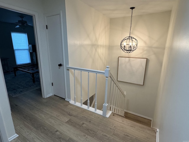 7306 Dakota Dr, North Little Rock, AR 72116 - stairs with wood finished floors, a chandelier, baseboards, and a ceiling fan