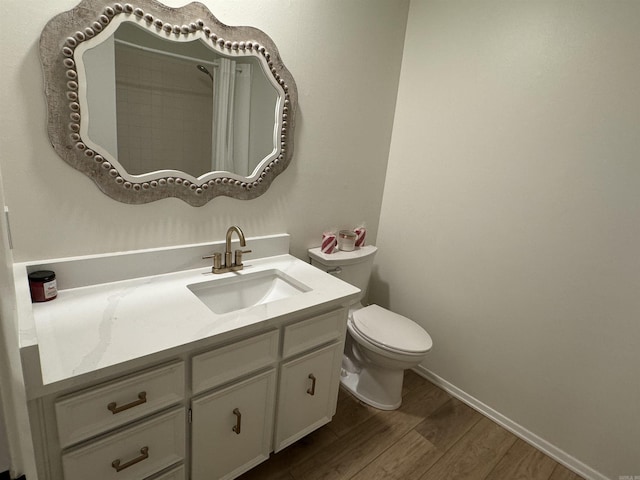 7306 Dakota Dr, North Little Rock, AR 72116 - full bathroom with wood finished floors, vanity, toilet, and baseboards