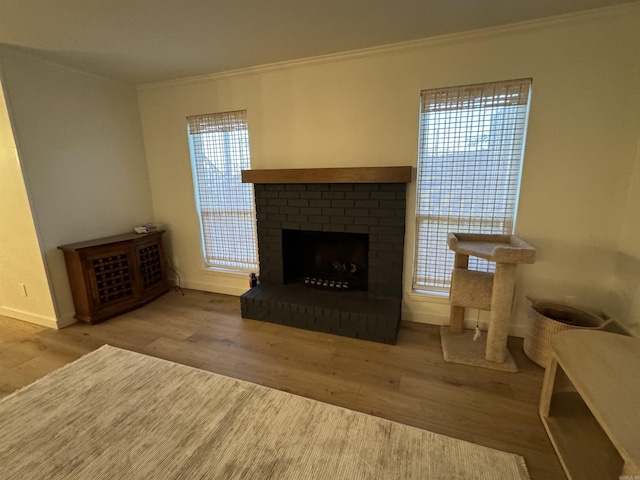 7306 Dakota Dr, North Little Rock, AR 72116 - living room featuring ornamental molding, wood finished floors, a fireplace, baseboards, and healthy amount of natural light