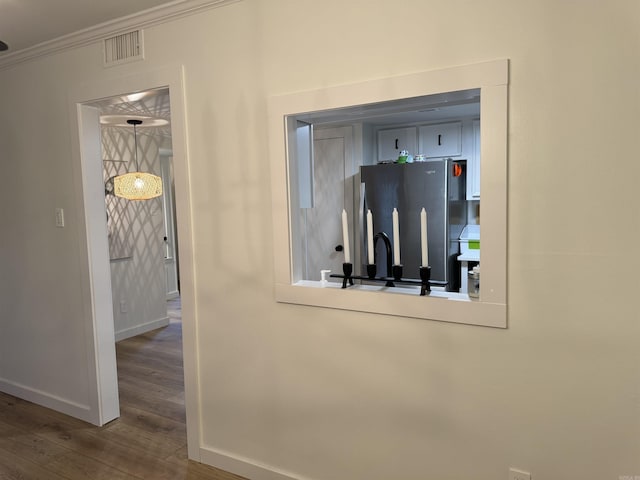 7306 Dakota Dr, North Little Rock, AR 72116 - detailed view of freestanding refrigerator, wood finished floors, baseboards, crown molding, and a sink