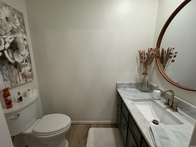 7306 Dakota Dr, North Little Rock, AR 72116 - half bath with wood finished floors, toilet, vanity, and baseboards