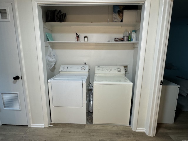 7306 Dakota Dr, North Little Rock, AR 72116 - washroom with separate washer and dryer and wood finished floors