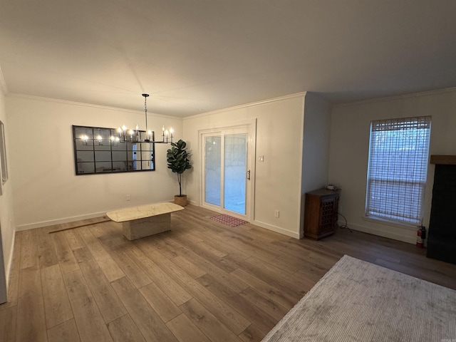 7306 Dakota Dr, North Little Rock, AR 72116 - unfurnished dining area featuring crown molding, a chandelier, wood finished floors, and baseboards