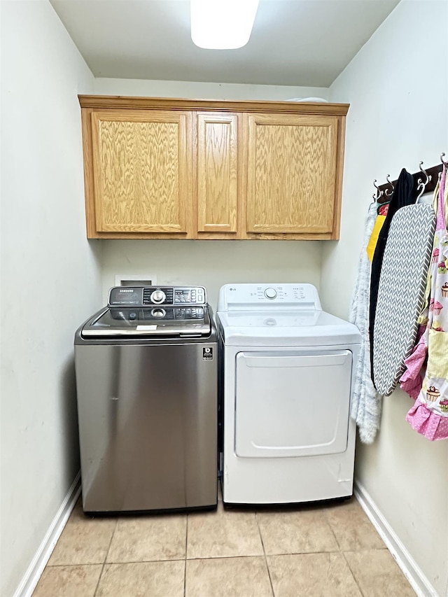 1041 Slatecreek Way, Lonsdale, AR 72087 - washroom with washer and dryer, cabinet space, baseboards, and light tile patterned flooring