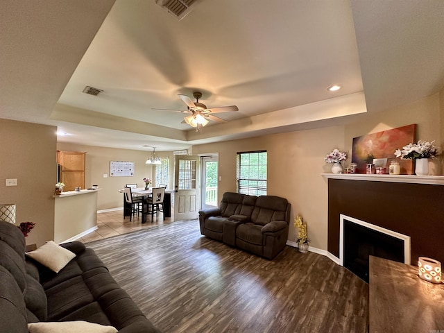 1041 Slatecreek Way, Lonsdale, AR 72087 - living area with a tray ceiling, baseboards, ceiling fan, a fireplace, and wood finished floors