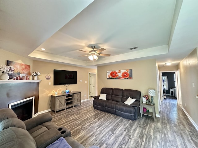 1041 Slatecreek Way, Lonsdale, AR 72087 - living room featuring a raised ceiling, wood finished floors, baseboards, a fireplace, and recessed lighting