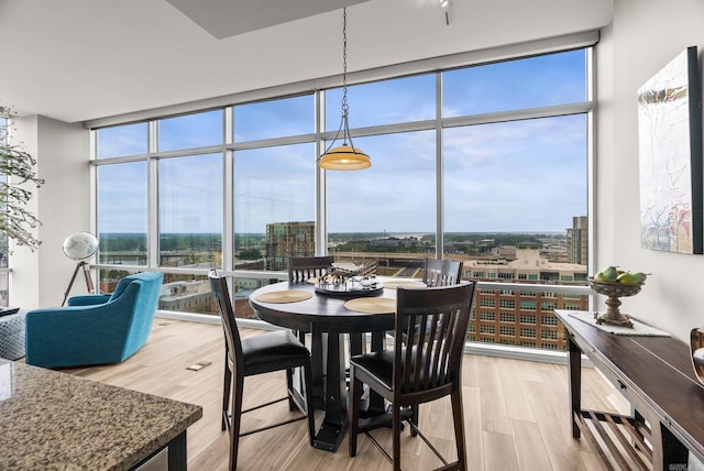 300 E Third # 1302, Little Rock, AR 72201 - dining area with expansive windows, light wood-type flooring, and a city view