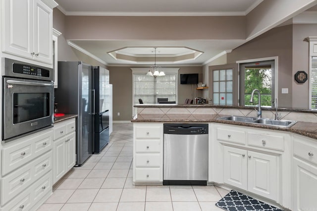 223 Maranes Cir, Maumelle, AR 72113 - kitchen featuring stainless steel appliances, a sink, light tile patterned floors, white cabinetry, and a tray ceiling