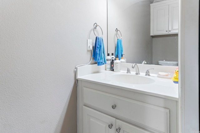 223 Maranes Cir, Maumelle, AR 72113 - bathroom featuring vanity, a textured wall, and toilet