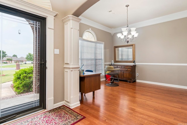 223 Maranes Cir, Maumelle, AR 72113 - foyer with decorative columns, light wood-style flooring, a chandelier, crown molding, and arched walkways