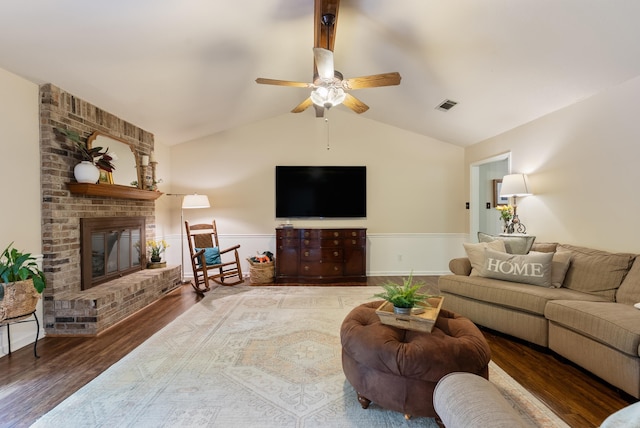 5623 Ridgeway Dr, Benton, AR 72019 - living room featuring lofted ceiling, wood finished floors, ceiling fan, a brick fireplace, and a wainscoted wall