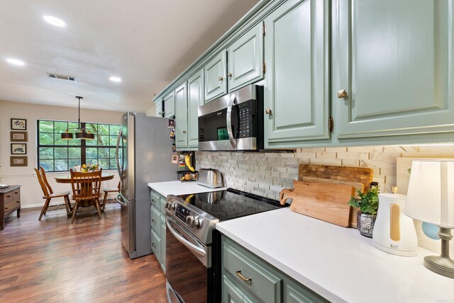 5623 Ridgeway Dr, Benton, AR 72019 - kitchen with stainless steel appliances, light countertops, backsplash, dark wood-style floors, and recessed lighting