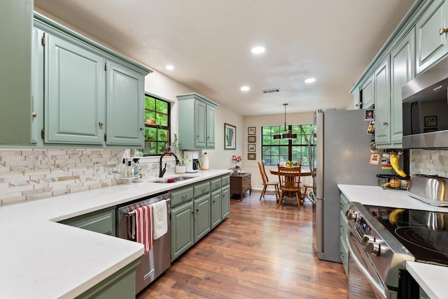 5623 Ridgeway Dr, Benton, AR 72019 - kitchen with a sink, stainless steel appliances, light countertops, backsplash, and recessed lighting