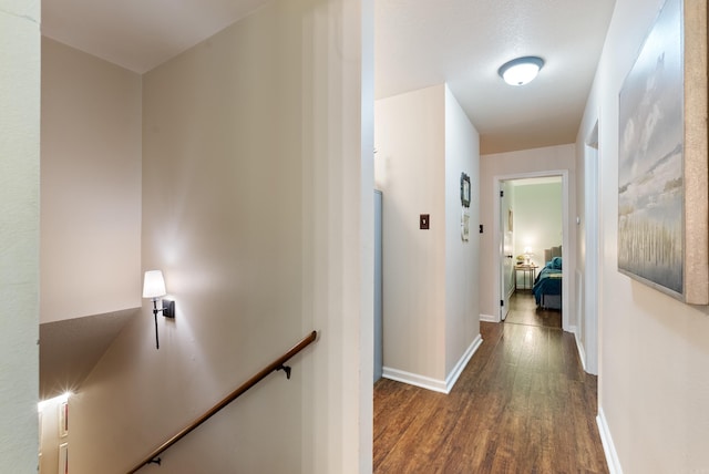 5623 Ridgeway Dr, Benton, AR 72019 - hallway with an upstairs landing, dark wood finished floors, and baseboards