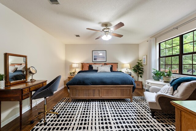 5623 Ridgeway Dr, Benton, AR 72019 - bedroom with wood finished floors, baseboards, and a textured ceiling