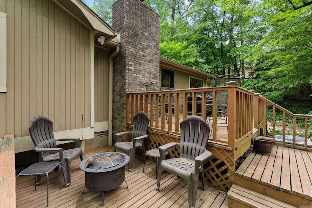 5623 Ridgeway Dr, Benton, AR 72019 - wooden deck featuring a fire pit and view of scattered trees