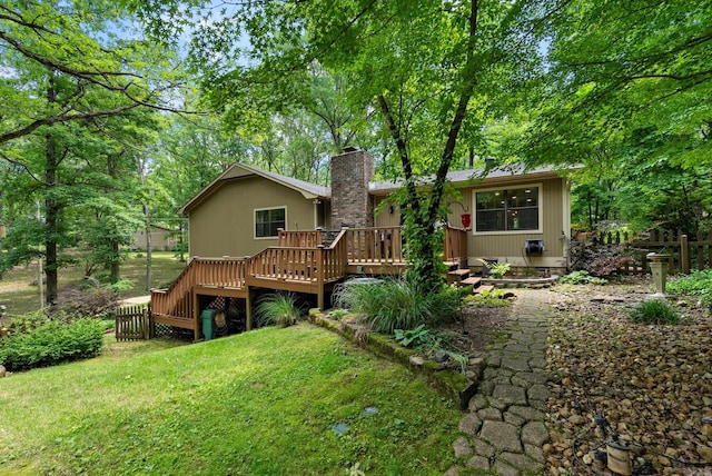 5623 Ridgeway Dr, Benton, AR 72019 - rear view of house with a wooden deck, a chimney, and a yard