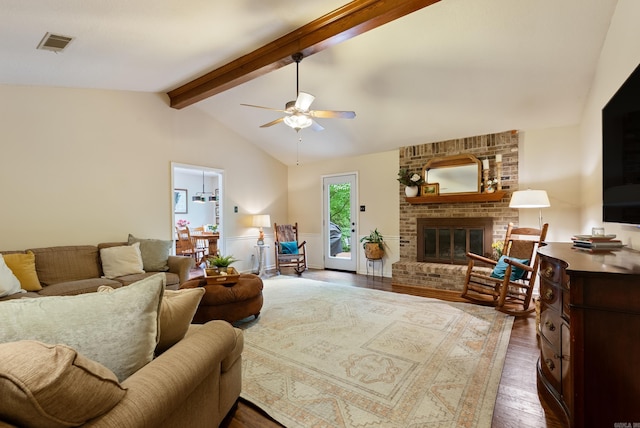 5623 Ridgeway Dr, Benton, AR 72019 - living room with dark wood finished floors, a ceiling fan, and a fireplace