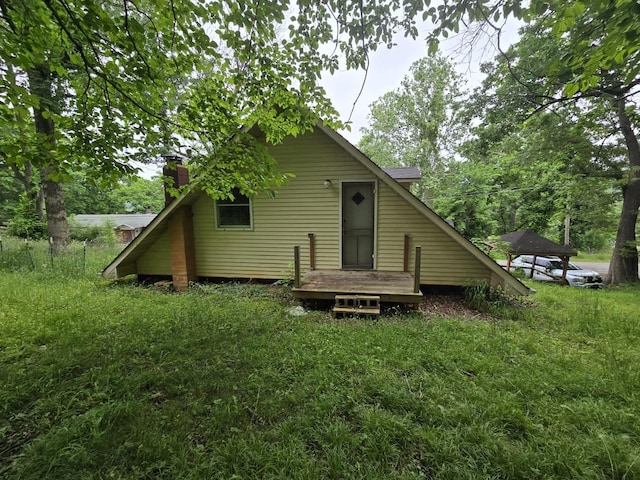 171 Riverbend Rd, Mammoth Spring, AR 72554 - back of property with a chimney and a wooden deck