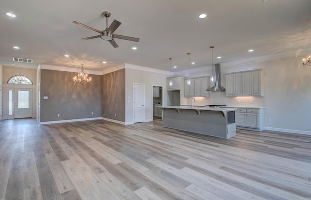 121 Majestic Cir, Maumelle, AR 72113 - kitchen featuring a chandelier, wall chimney range hood, ceiling fan, a sink, and recessed lighting