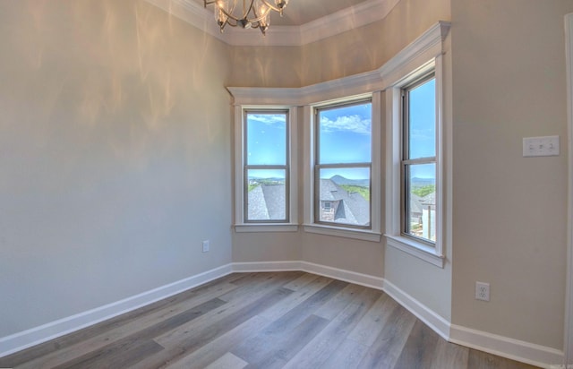 121 Majestic Cir, Maumelle, AR 72113 - spare room featuring a chandelier, ornamental molding, wood finished floors, baseboards, and a towering ceiling
