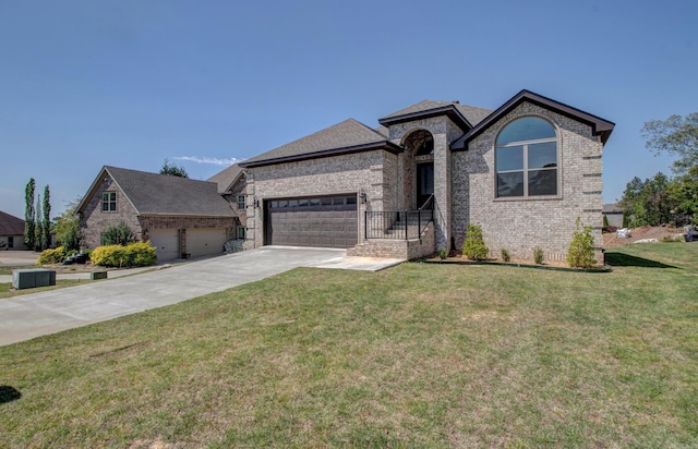 121 Majestic Cir, Maumelle, AR 72113 - french country inspired facade with an attached garage, driveway, a front yard, and brick siding