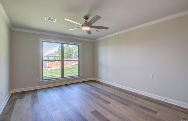 121 Majestic Cir, Maumelle, AR 72113 - unfurnished room with wood finished floors, ornamental molding, a ceiling fan, and baseboards
