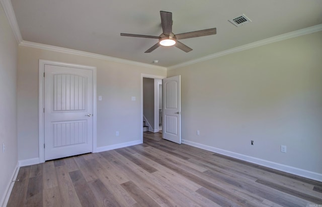 121 Majestic Cir, Maumelle, AR 72113 - unfurnished bedroom with crown molding, light wood-type flooring, baseboards, and ceiling fan