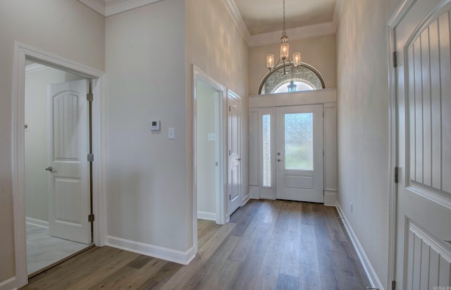 121 Majestic Cir, Maumelle, AR 72113 - entryway with a chandelier, wood finished floors, ornamental molding, a high ceiling, and baseboards