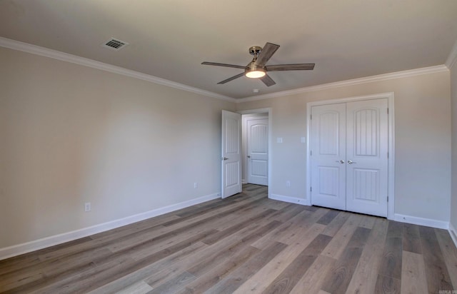 121 Majestic Cir, Maumelle, AR 72113 - unfurnished bedroom with wood finished floors, ornamental molding, baseboards, a closet, and ceiling fan
