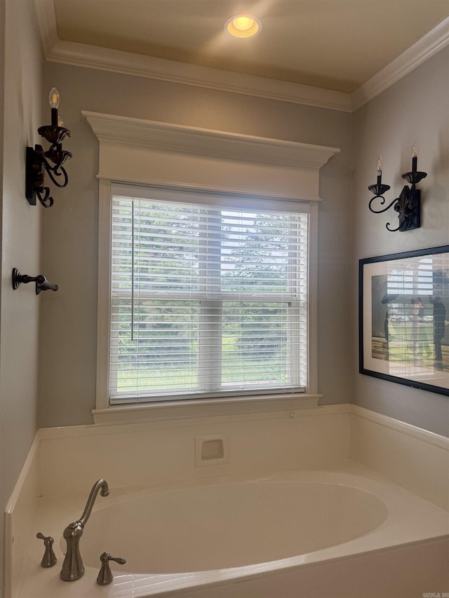 bathroom featuring plenty of natural light, a garden tub, and crown molding