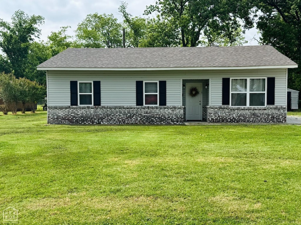 107 Von, Marked Tree, AR 72365 - ranch-style house with brick siding, a front yard, and roof with shingles