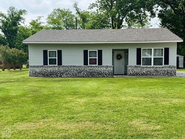 107 Von, Marked Tree, AR 72365 - ranch-style house with brick siding, a front yard, and roof with shingles
