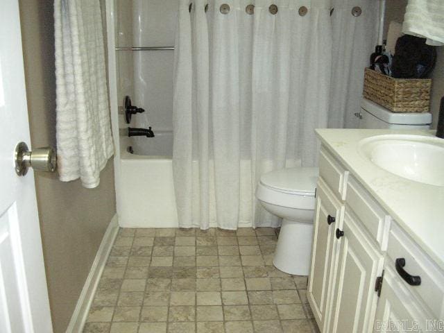 11 Sharondale Ct, Maumelle, AR 72113 - full bathroom with baseboards, toilet, vanity, stone finish floors, and shower / bath combo with shower curtain