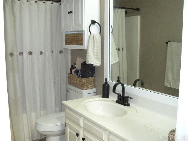 11 Sharondale Ct, Maumelle, AR 72113 - full bath featuring toilet, vanity, and a shower with shower curtain