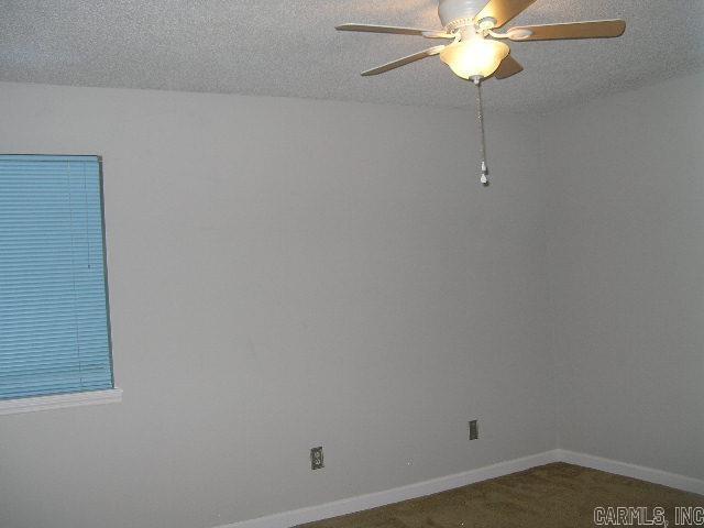 11 Sharondale Ct, Maumelle, AR 72113 - carpeted spare room featuring a ceiling fan, baseboards, and a textured ceiling
