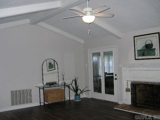 11 Sharondale Ct, Maumelle, AR 72113 - living area featuring beamed ceiling, wood finished floors, a brick fireplace, and ceiling fan