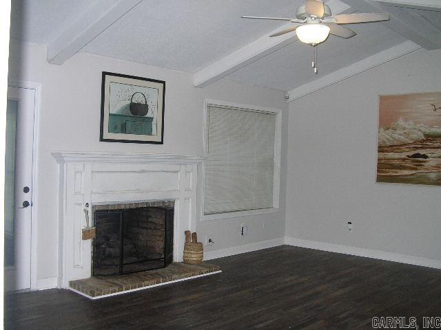 11 Sharondale Ct, Maumelle, AR 72113 - unfurnished living room with a ceiling fan, dark wood finished floors, a brick fireplace, and baseboards