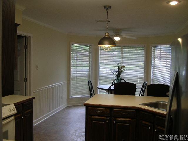 11 Sharondale Ct, Maumelle, AR 72113 - kitchen with a ceiling fan, ornamental molding, freestanding refrigerator, light countertops, and electric stove