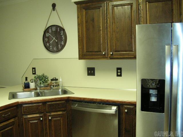 11 Sharondale Ct, Maumelle, AR 72113 - kitchen featuring appliances with stainless steel finishes, a sink, light countertops, and dark brown cabinets