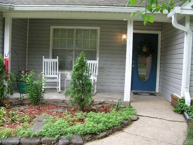 11 Sharondale Ct, Maumelle, AR 72113 - entrance to property featuring a porch and roof with shingles