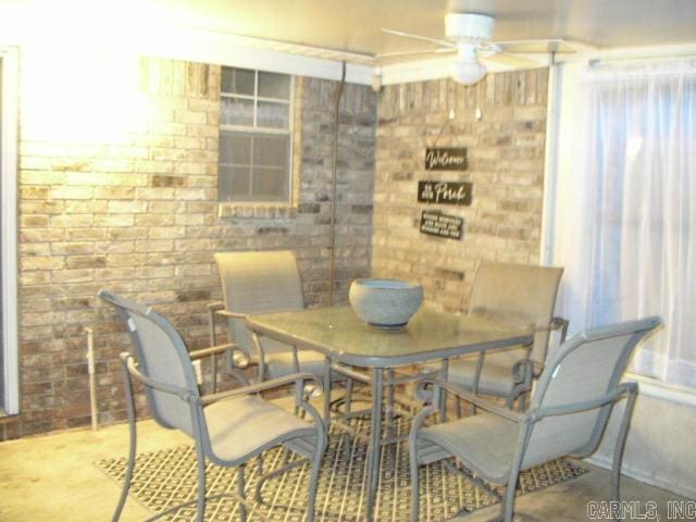11 Sharondale Ct, Maumelle, AR 72113 - dining space featuring brick wall and ceiling fan