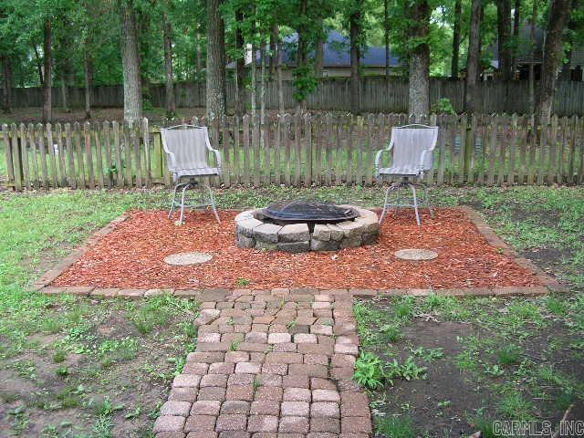 11 Sharondale Ct, Maumelle, AR 72113 - view of yard with a fire pit and fence
