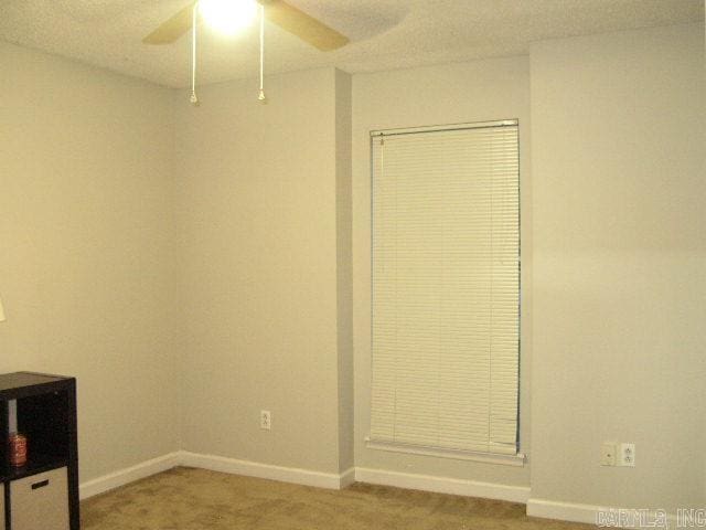 11 Sharondale Ct, Maumelle, AR 72113 - unfurnished bedroom with light carpet, baseboards, and a ceiling fan