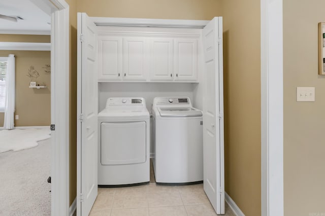 41 Winners Cir, Cabot, AR 72023 - laundry area with cabinet space, washing machine and dryer, light tile patterned flooring, and baseboards
