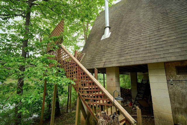1 Kiwanie Crk, Cherokee Village, AR 72542 - view of property exterior with stairs and roof with shingles